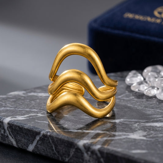 Triple-layer wavy statement ring.