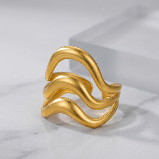 Triple-layer wavy statement ring.